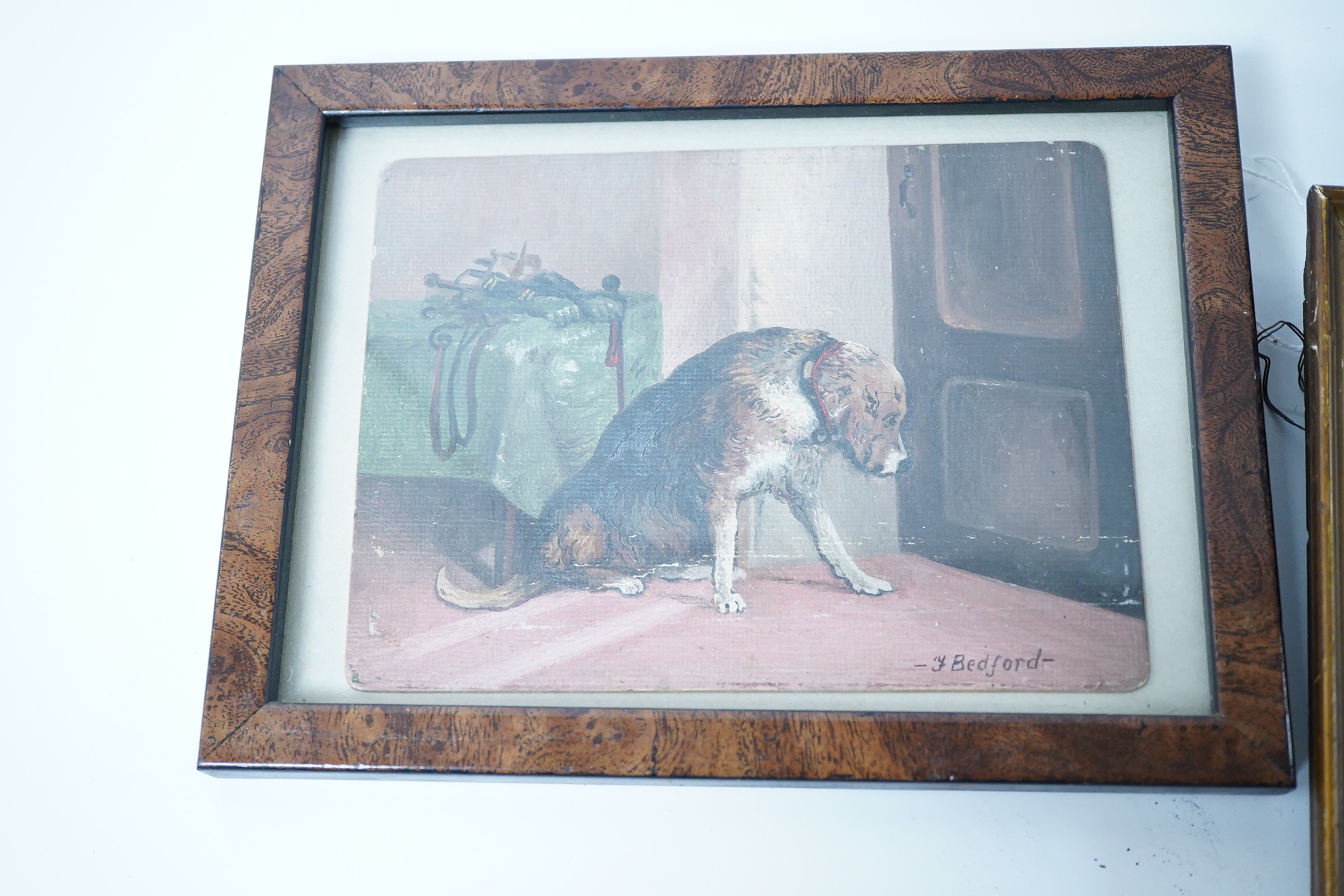 A small group of various collectables including an Edwardian oil on canvas board, study of a dog, a 19th century woolwork, cast iron bottle opener in the form of a parrot and an Art Deco bookend surmounted with a cat
